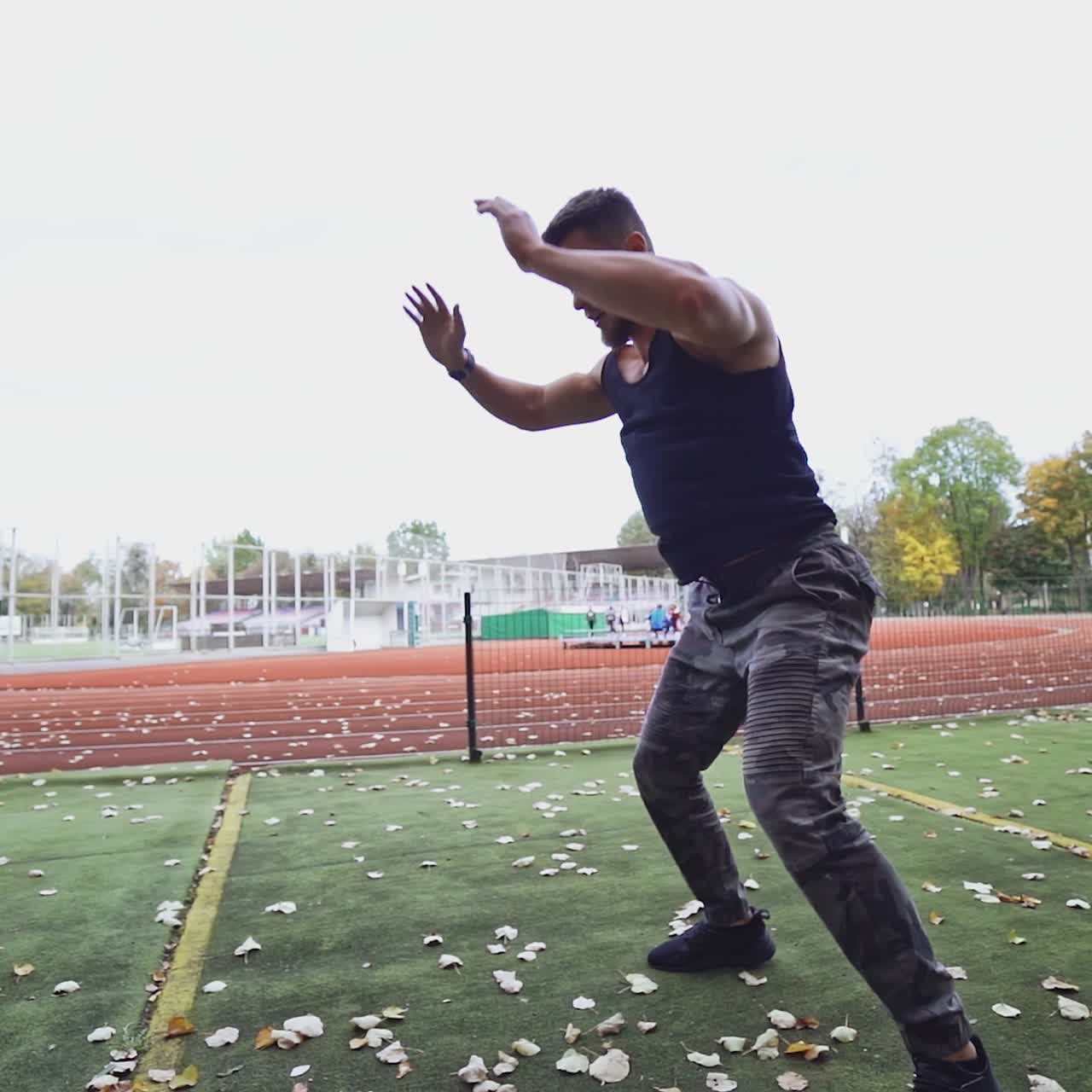 . Man training at stadium. Male with muscular fit and slim body at the city stadium