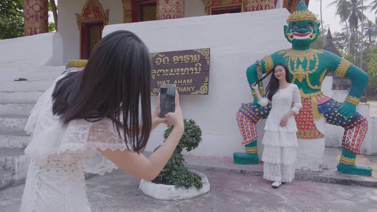 Girl Taking Picture Of Another Girl Near Temple, Slow Motion