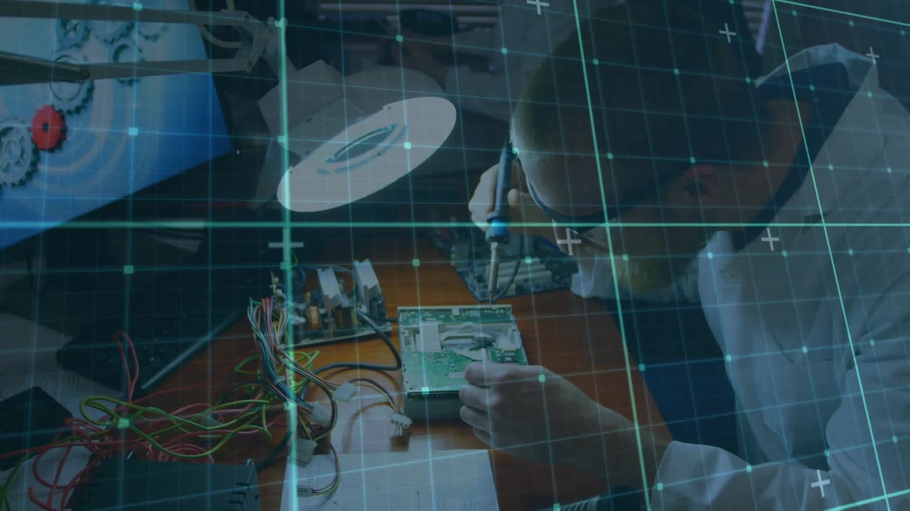 Animation of grid pattern over high angle view of caucasian male engineer repairing motherboard