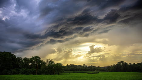 Sunset-during-a-dark-and-dramatic-cloudscape-time-lapse-in-the-summer-countryside