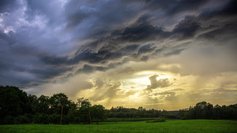 sunset during a dark and dramatic cloudscape time lapse in the summer countryside