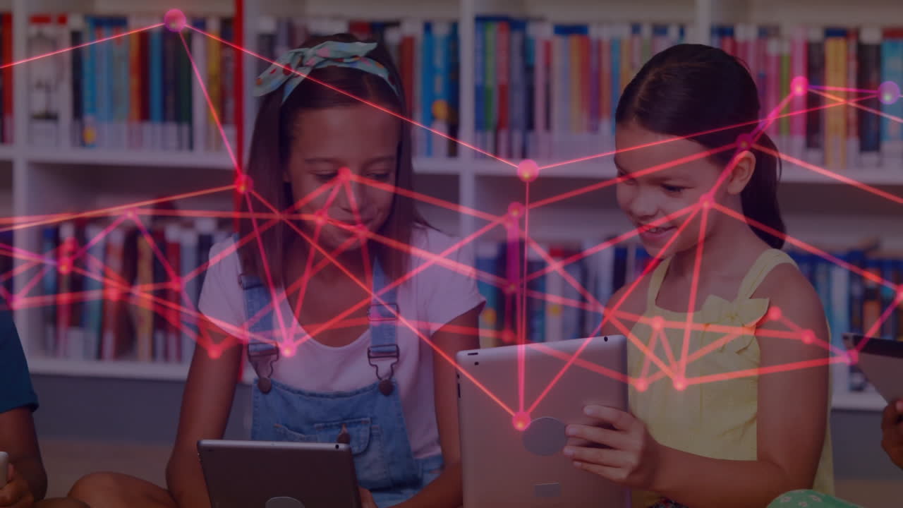 In school library, children using tablets with animation of digital network overlay