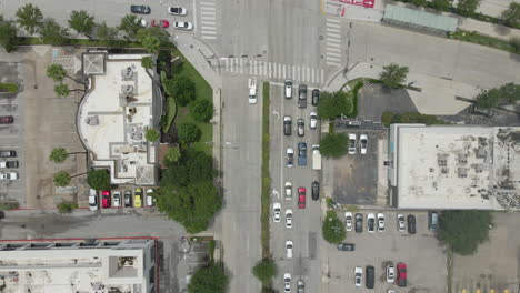 aerial top down shot of city traffic at an intersection in downtown houston, texas, usa