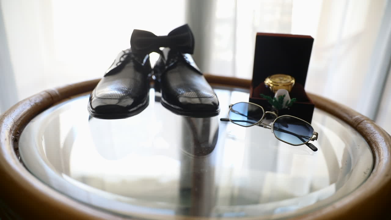 Groom's Accessories with the bow tie on the table for the Wedding Day - push out