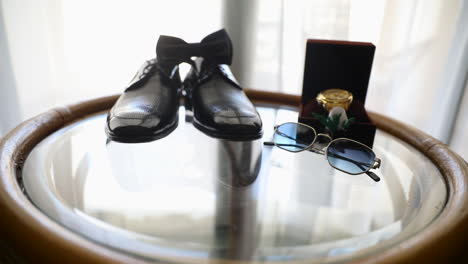 groom's accessories with the bow tie on the table for the wedding day - push out