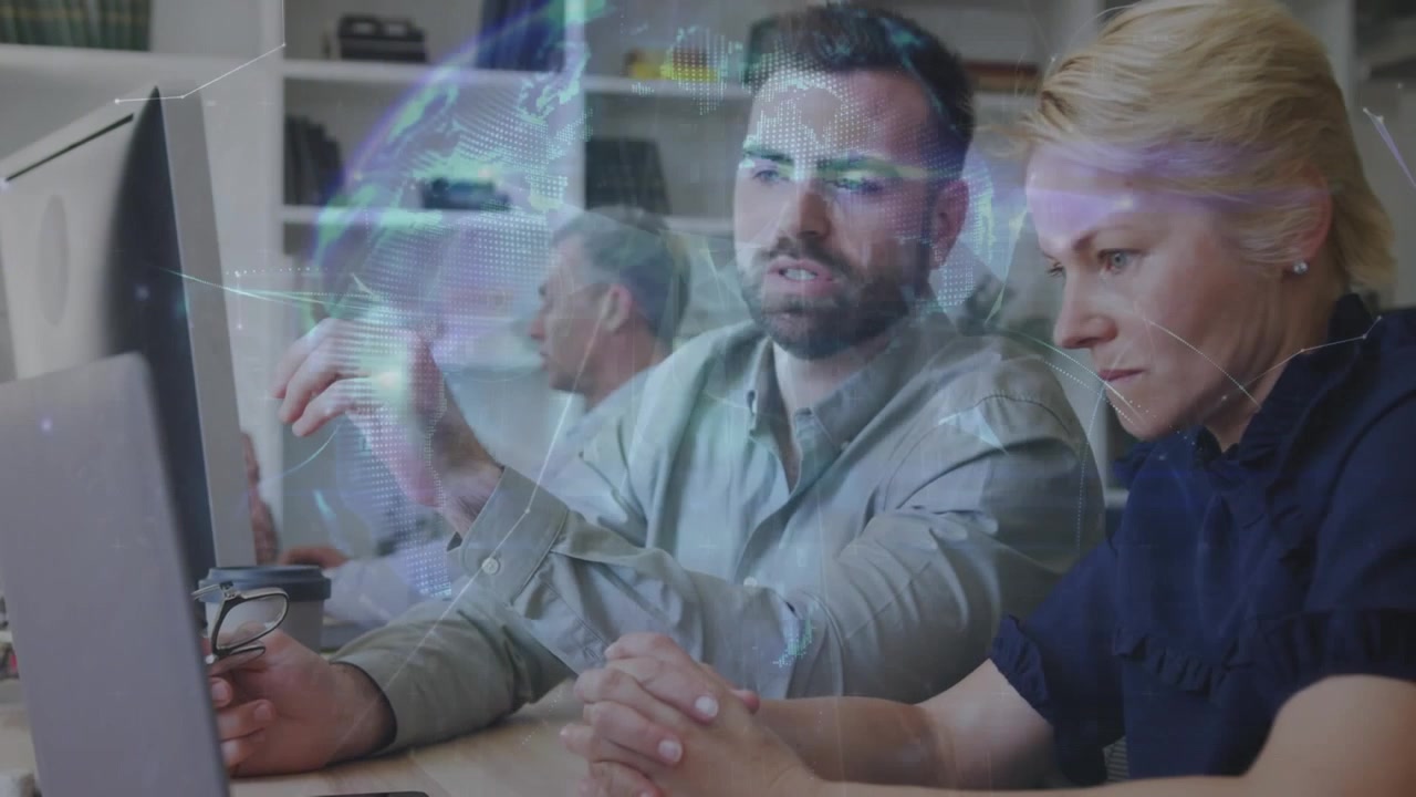 Colleagues Collaborating on Digital Project in Modern Office