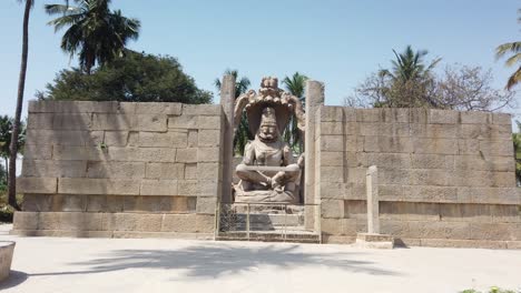 tracking shot into giant statue at ruined temple at hampi, karnataka, india