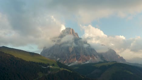 cloudy mountain top sassolungo during sunset, dolomites, south tyrol