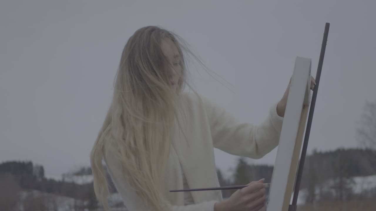 Woman Painting Outdoors in Winter