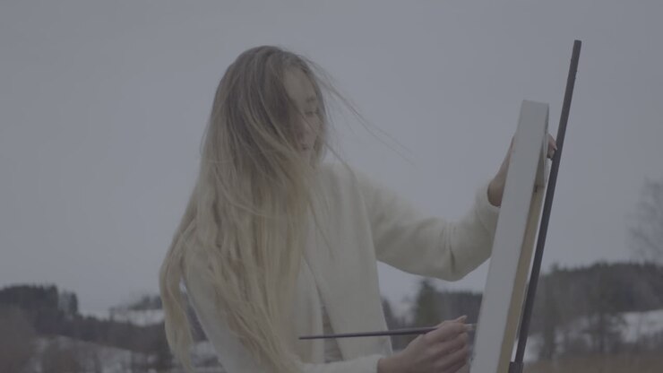 Woman Painting Outdoors in Winter