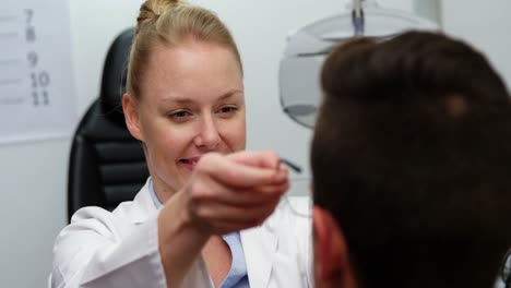 female optometrist prescribing spectacles to patient