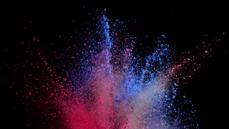 super slow motion of colored powder explosion isolated on dark background.