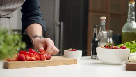 crop chef cutting strawberries on board