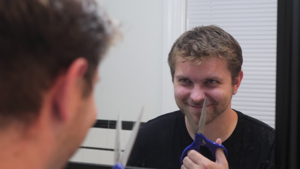 Man has mental breakdown and chops off hair with scissors in slow motion 4K