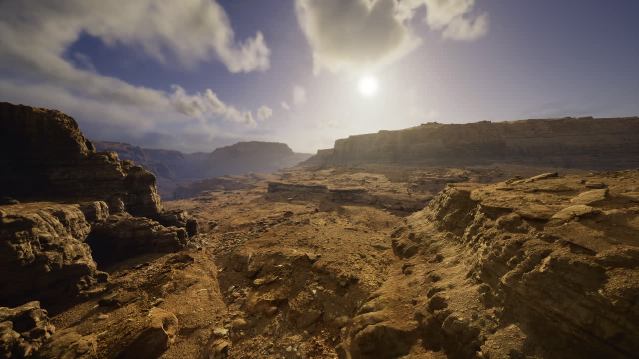 Landscape view of rocky terrain under a bright sky at sunset