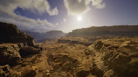 landscape view of rocky terrain under a bright sky at sunset