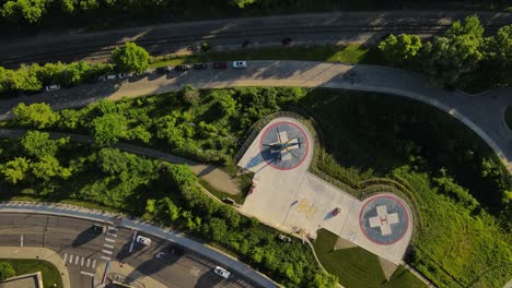 medical helicopter on landing pad near hospital, aerial top down view