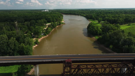 highway bridge over river near twin city riverfront park, arkansas, usa - aerial pullback