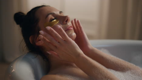 serene girl spa procedures at bathroom closeup. relaxed woman under eye patches