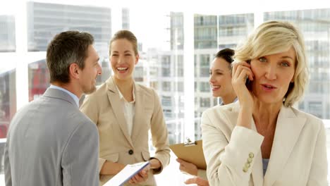 Happy-businesswoman-laughing-on-phone