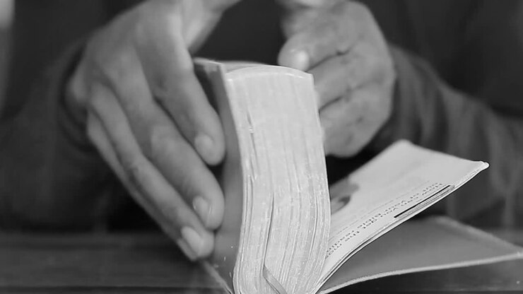 praying with hands together with holy bible on table with people stock video stock footage