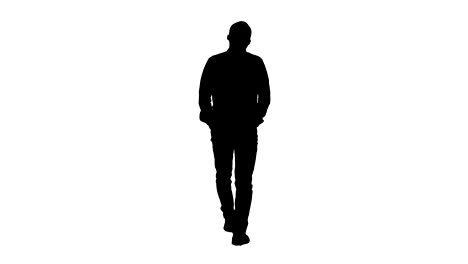 silhouette young man walking with hands in his pockets and whistles