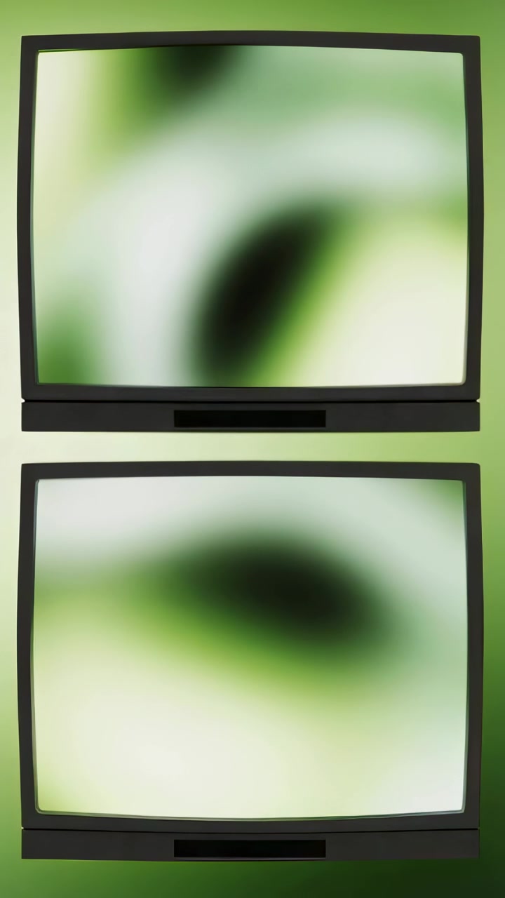 Vertical video: Frames causing green blobs moving across two black screens on green wall, panels