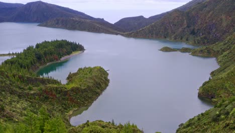 woody shoreline of lagoa do fogo crater lake in azores, aerial view