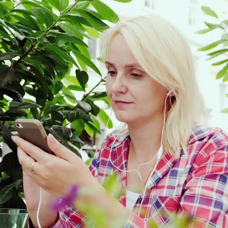 a young blonde woman is resting in a cafe on the summer terrace 1