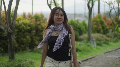 young woman walking in a beautiful park