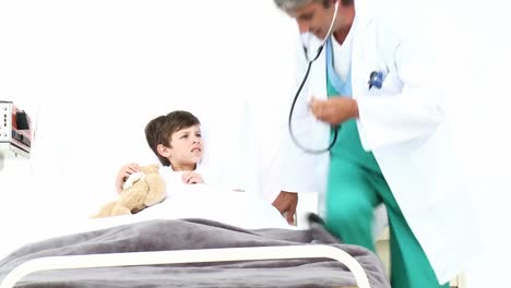 attentive doctor playing with a little boy