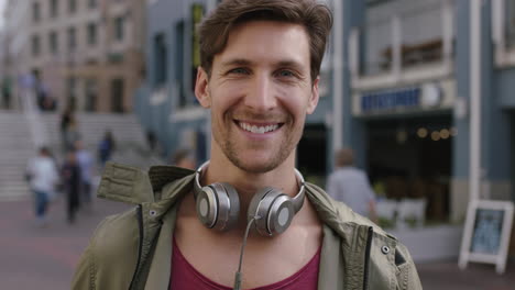 portrait of cheerful attractive young man smiling confident at camera in busy urban background