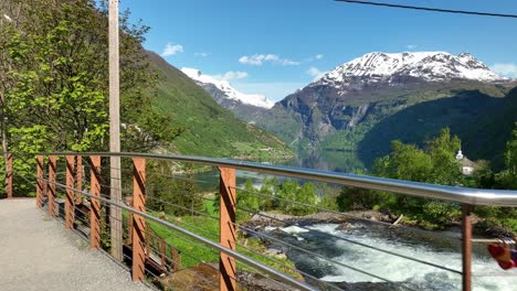 tourist walkway close to river in geiranger norway - tourists point of view showing fjord and river - handheld stabilized pov clip