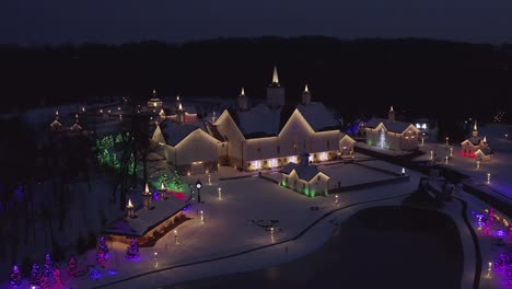 large farm with star light barn decorated with christmas holiday lights at night