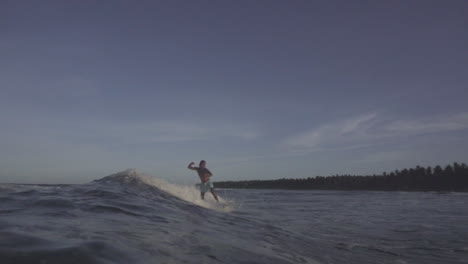 asian filipino surfers enjoying small waves in gloomy weather