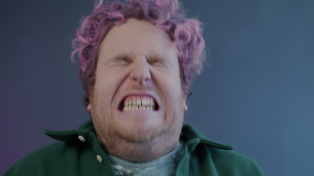 Man with Pink Hair Making a Disgusted Expression