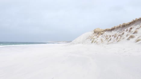 Scenic-view-of-beautiful-white-sandy-West-Beach-on-Berneray,-Outer-Hebrides-with-sand-dunes,-during-wild,-windy-weather-conditions,-in-Western-Scotland-UK