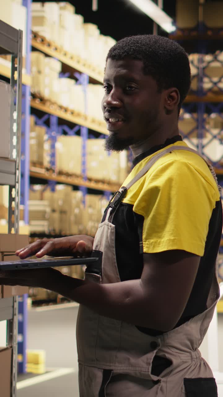 Vertical Video Black male staff verifying inventory pallets in e-commerce logistics center