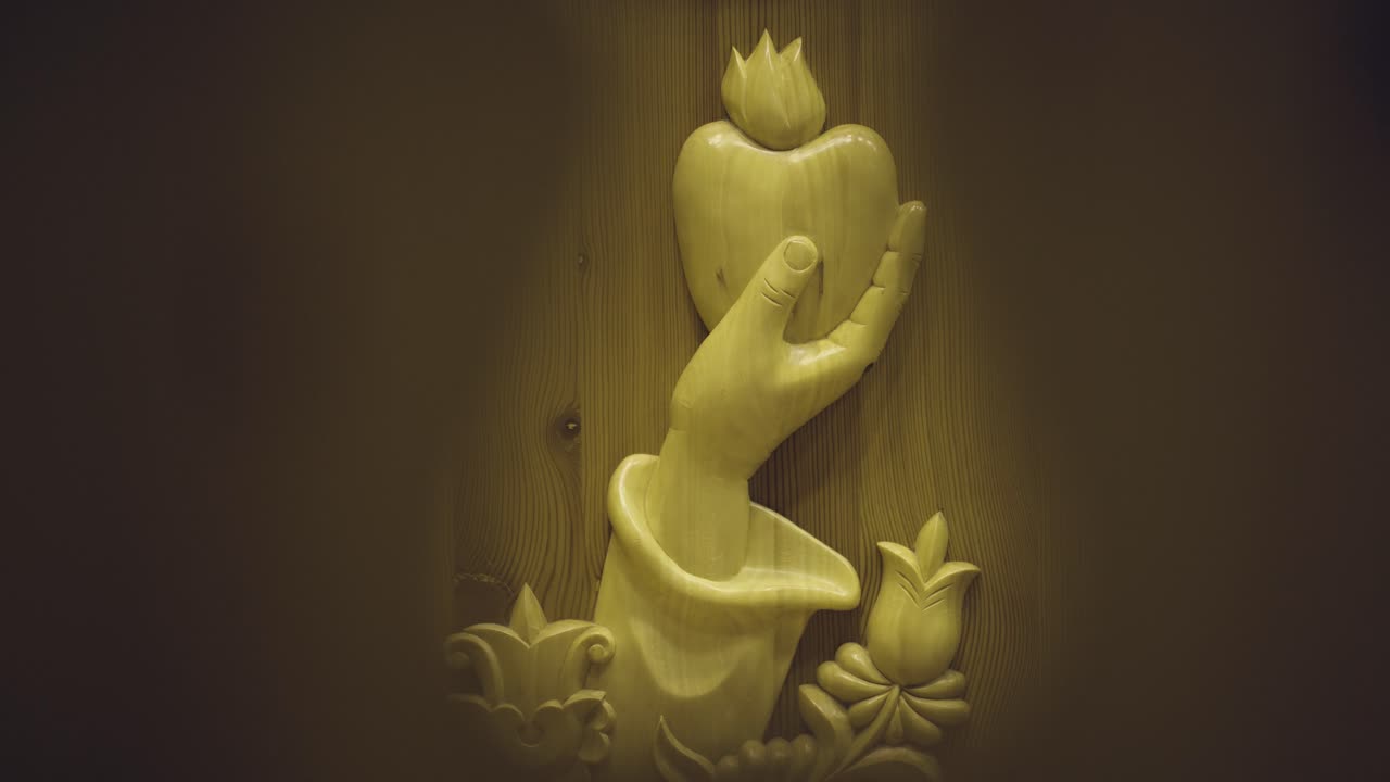 Symbol in a wooden church A hand holds an apple and tulips