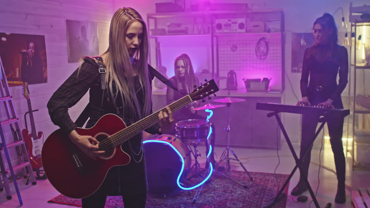 Female Rock Band Performing Music On Stage