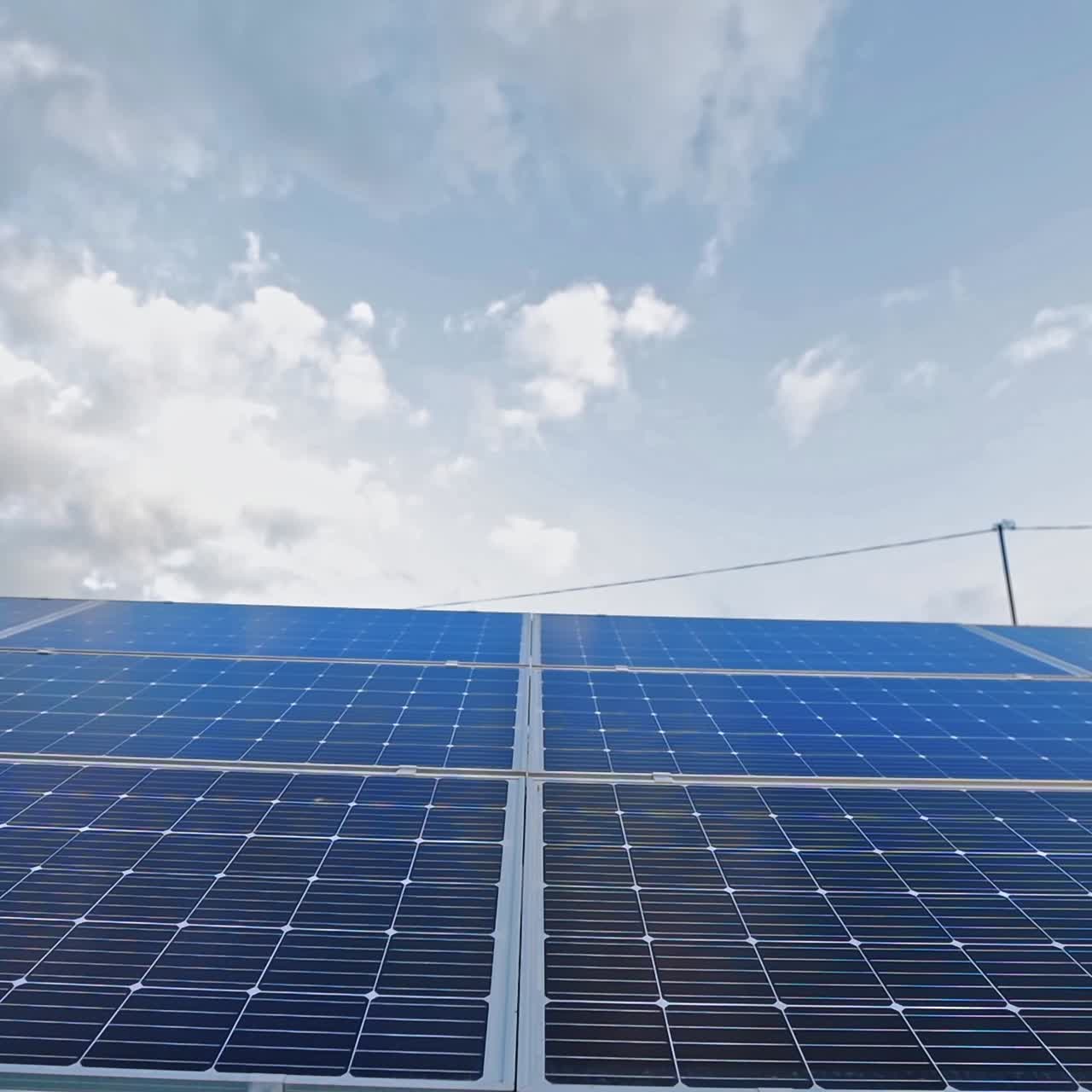 Blue photovoltaic solar panel. Sunny batteries in a bright sunny day. Alternative source of energy. Close-up.