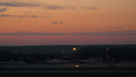 Airport-with-plane-taking-off-in-the-dusk