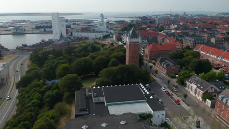 Aerial-view-slow-camera-rotation-around-the-Water-Tower-of-Esbjerg,-Denmark.-Esbjerg-Water-Tower-is-an-iconic-water-tower-at-the-top-of-a-cliff-overlooking-the-harbor