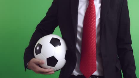 soccer manager holding a soccer ball with green screen, video in 4k