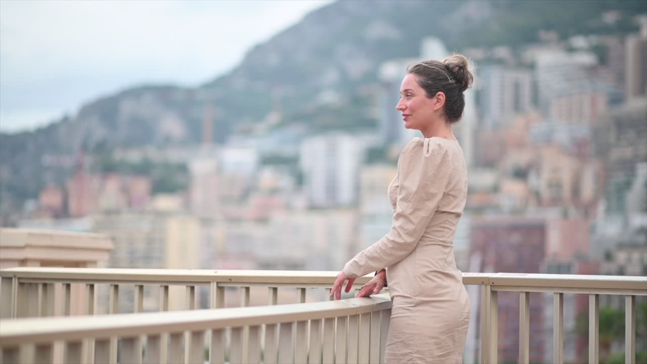 Woman in brown dress posing in Monte Carlo district, Monaco cityscape
