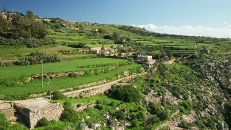 AERIAL:-Houses-Built-Upon-Magrr-Ix-Xini-bay-Hills-on-a-Sunny-Day-in-Gozo-Island