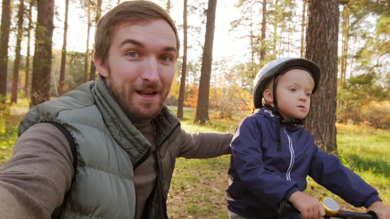 Father and Son Bike Ride in the Autumn Forest