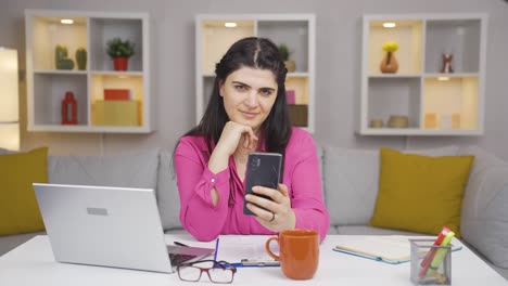home office worker woman talking on the phone facetime happily.
