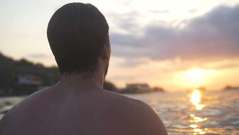 man in ocean submerges in water and comes out in slow motion