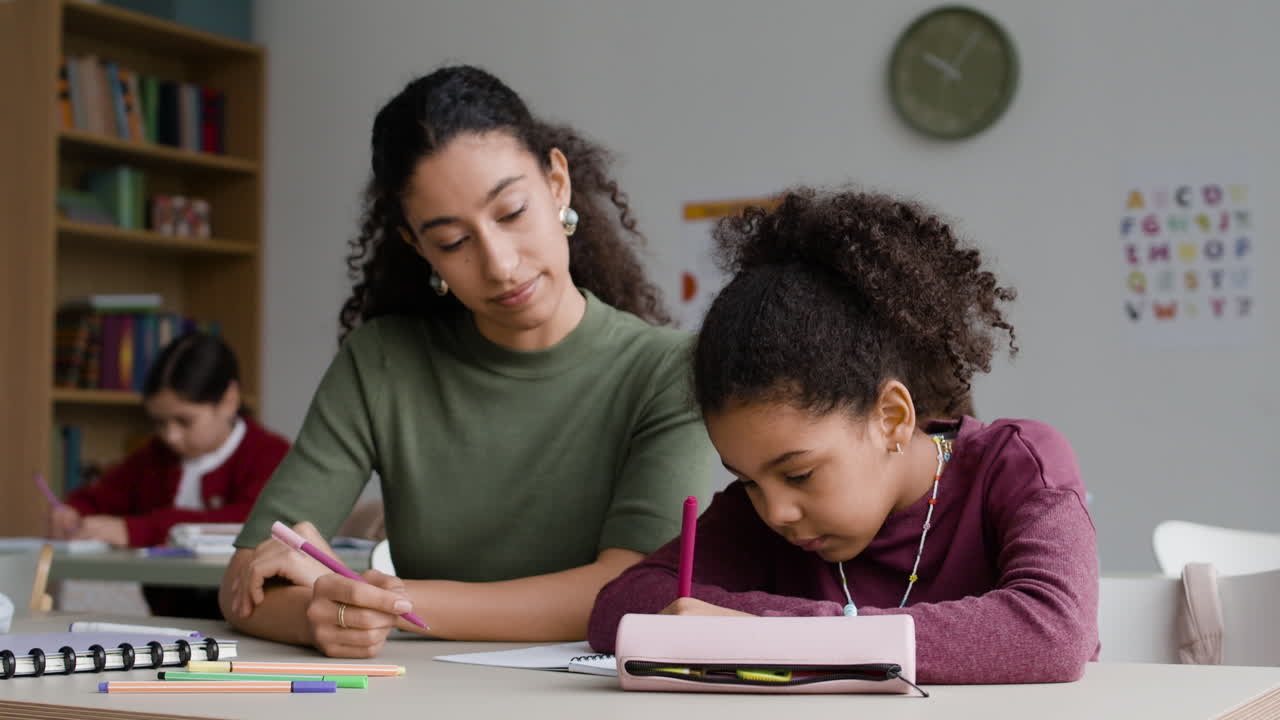 Teacher assisting student in classroom